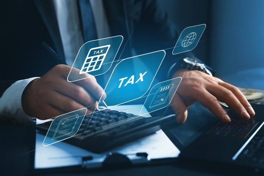 Financial research,government taxes and calculation tax return concept. Businessman using the laptop to fill in the income tax online return form for payment.
